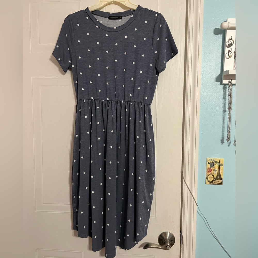 A soft, knee length, blue/grey polka dot pattern maxi dress